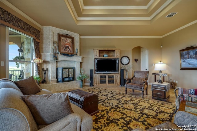 286 Settlers, Comfort, TX 78013 - living area featuring a raised ceiling, arched walkways, a high end fireplace, crown molding, and baseboards