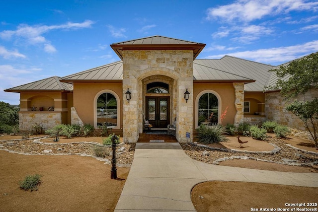 286 Settlers, Comfort, TX 78013 - property entrance featuring a standing seam roof, french doors, metal roof, and stone siding