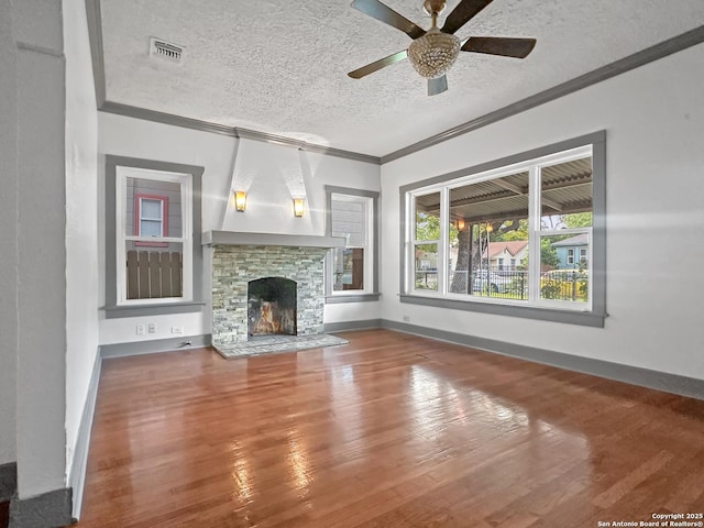 1806 W Magnolia, San Antonio, TX 78201 - unfurnished living room with crown molding, a textured ceiling, wood finished floors, ceiling fan, and a fireplace