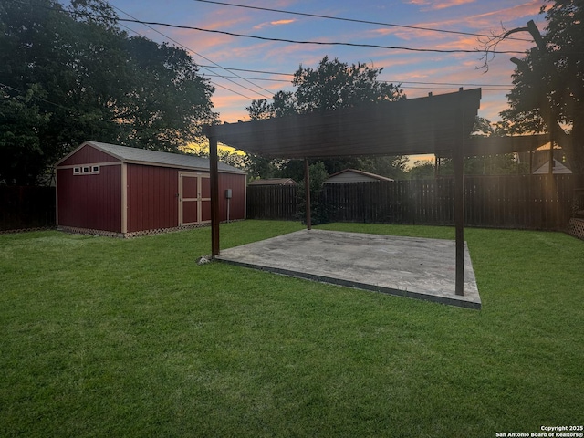 1806 W Magnolia, San Antonio, TX 78201 - yard at dusk with a patio, a storage shed, an outbuilding, and a detached carport