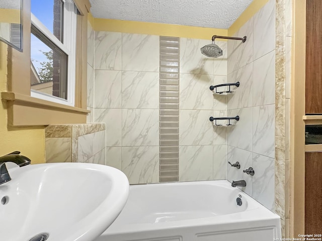 1806 W Magnolia, San Antonio, TX 78201 - bathroom with a sink, washtub / shower combination, and a textured ceiling
