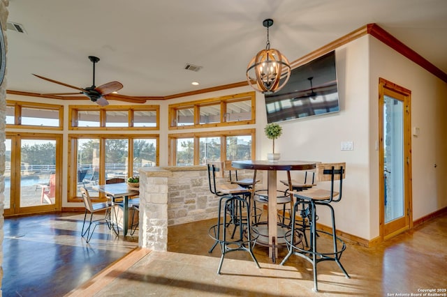 24005 Pedernales Canyon Trl, Spicewood, TX 78669 - dining area with ornamental molding, baseboards, plenty of natural light, a ceiling fan, and a chandelier