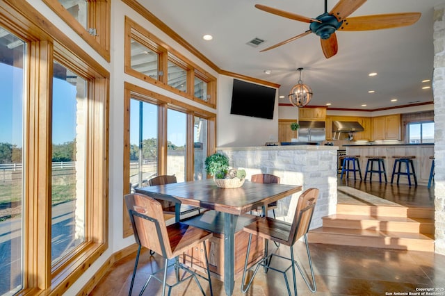 24005 Pedernales Canyon Trl, Spicewood, TX 78669 - dining room featuring recessed lighting, crown molding, ceiling fan, and a chandelier