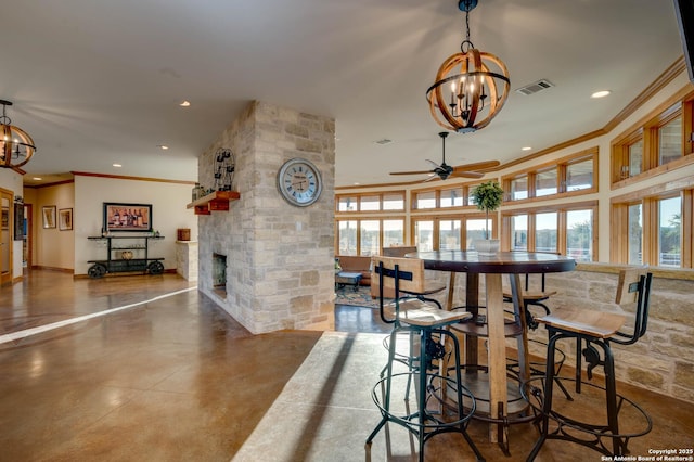 24005 Pedernales Canyon Trl, Spicewood, TX 78669 - dining space featuring a chandelier, ornamental molding, ceiling fan, recessed lighting, and concrete floors