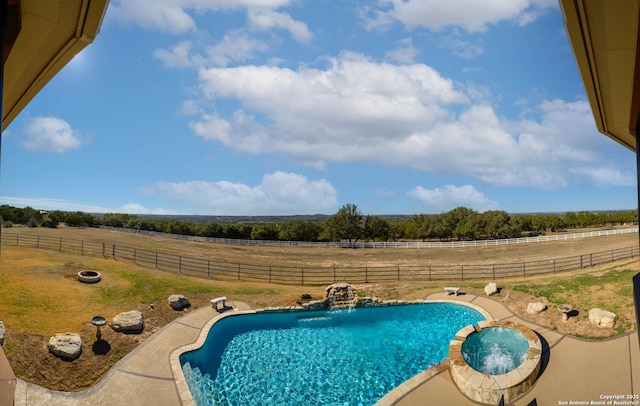 24005 Pedernales Canyon Trl, Spicewood, TX 78669 - view of pool featuring a view of countryside, a pool with connected hot tub, and a fenced backyard