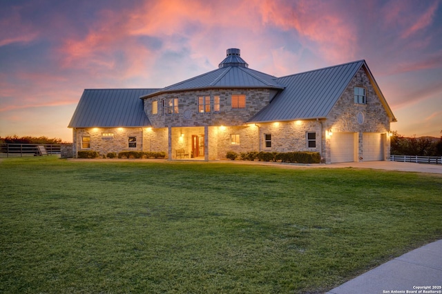 24005 Pedernales Canyon Trl, Spicewood, TX 78669 - view of front of property featuring a standing seam roof, a garage, stone siding, and metal roof