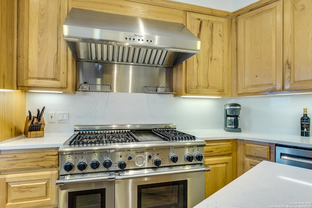 24005 Pedernales Canyon Trl, Spicewood, TX 78669 - kitchen with double oven range, wall chimney range hood, light countertops, and dishwashing machine