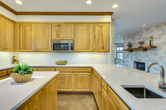 24005 Pedernales Canyon Trl, Spicewood, TX 78669 - kitchen featuring stainless steel microwave, a sink, recessed lighting, a stone fireplace, and tasteful backsplash