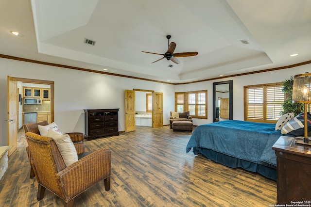 24005 Pedernales Canyon Trl, Spicewood, TX 78669 - bedroom featuring a tray ceiling, wood finished floors, recessed lighting, ornamental molding, and connected bathroom