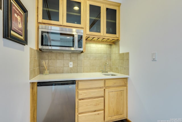 24005 Pedernales Canyon Trl, Spicewood, TX 78669 - kitchen with stainless steel microwave, a sink, refrigerator, light brown cabinetry, and light countertops