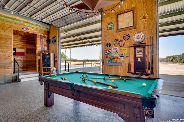 24005 Pedernales Canyon Trl, Spicewood, TX 78669 - game room featuring wooden walls, billiards table, healthy amount of natural light, and speckled floor