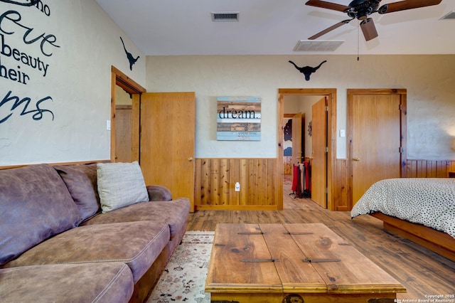 24005 Pedernales Canyon Trl, Spicewood, TX 78669 - bedroom featuring wood finished floors, a wainscoted wall, and wood walls