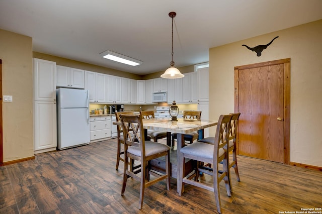 24005 Pedernales Canyon Trl, Spicewood, TX 78669 - dining room featuring dark wood-style floors and baseboards