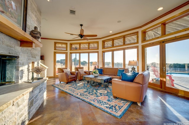 24005 Pedernales Canyon Trl, Spicewood, TX 78669 - living room with crown molding, plenty of natural light, finished concrete floors, a fireplace, and recessed lighting