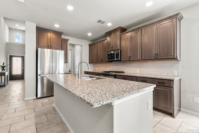 2126 Elysian, San Antonio, TX 78253 - kitchen with appliances with stainless steel finishes, a sink, backsplash, a center island with sink, and recessed lighting