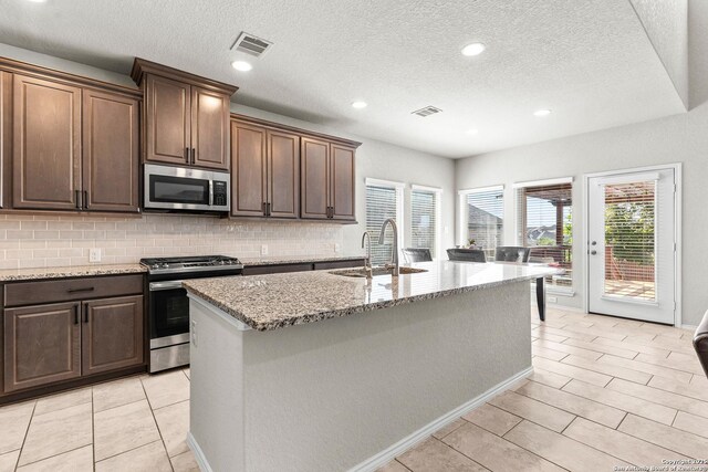 2126 Elysian, San Antonio, TX 78253 - kitchen featuring appliances with stainless steel finishes, plenty of natural light, a sink, decorative backsplash, and a textured ceiling