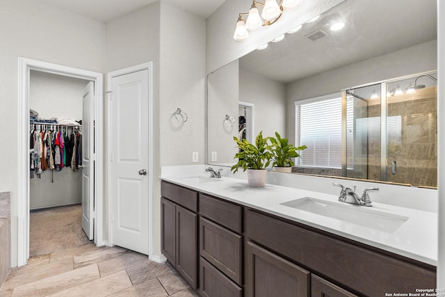 2126 Elysian, San Antonio, TX 78253 - bathroom with a shower stall, double vanity, and a spacious closet