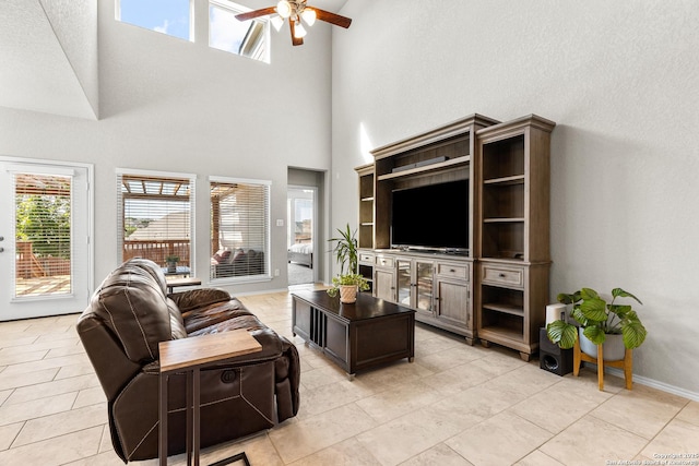 2126 Elysian, San Antonio, TX 78253 - living area featuring a ceiling fan, healthy amount of natural light, a high ceiling, light tile patterned floors, and baseboards