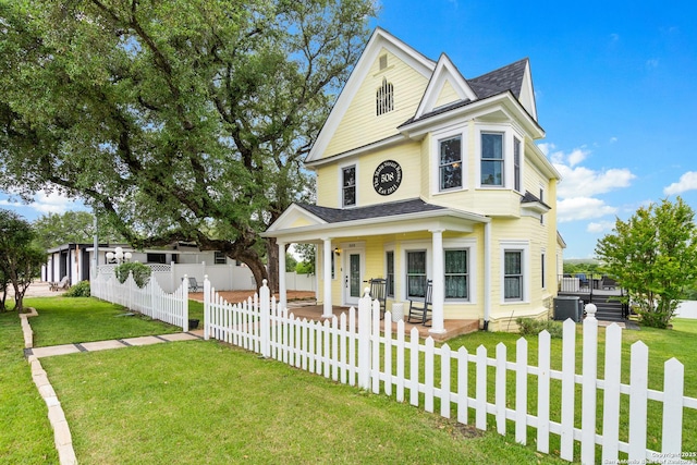 508 Main, Marble Falls, TX 78654 - view of front of home with a shingled roof, covered porch, and central AC