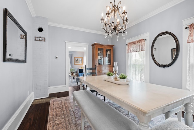 508 Main, Marble Falls, TX 78654 - dining space with ornamental molding, baseboards, dark wood finished floors, and a chandelier