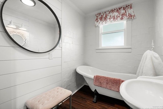 508 Main, Marble Falls, TX 78654 - full bathroom featuring wood finished floors, a sink, a soaking tub, and ornamental molding