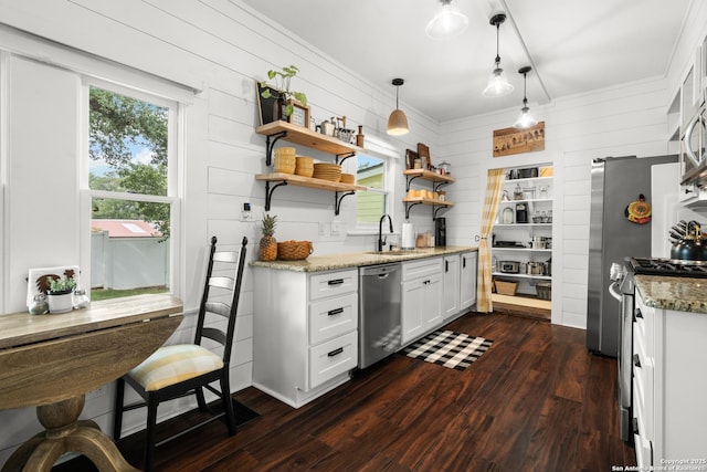 508 Main, Marble Falls, TX 78654 - kitchen featuring appliances with stainless steel finishes, a sink, dark wood-style flooring, wood walls, and open shelves