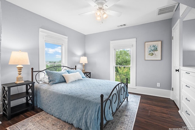 508 Main, Marble Falls, TX 78654 - bedroom with dark wood-style flooring, baseboards, and a ceiling fan