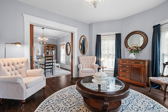 508 Main, Marble Falls, TX 78654 - living room featuring a chandelier, healthy amount of natural light, wood finished floors, crown molding, and baseboards