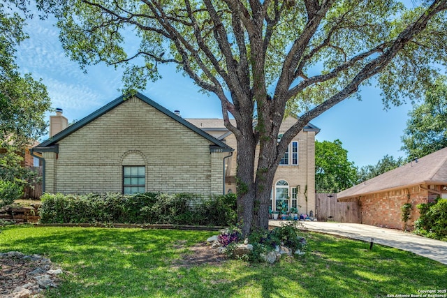 1027 Hedgestone, San Antonio, TX 78258 - view of front facade with brick siding and a chimney