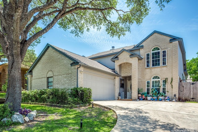 1027 Hedgestone, San Antonio, TX 78258 - view of front of house with brick siding, an attached garage, concrete driveway, and a shingled roof