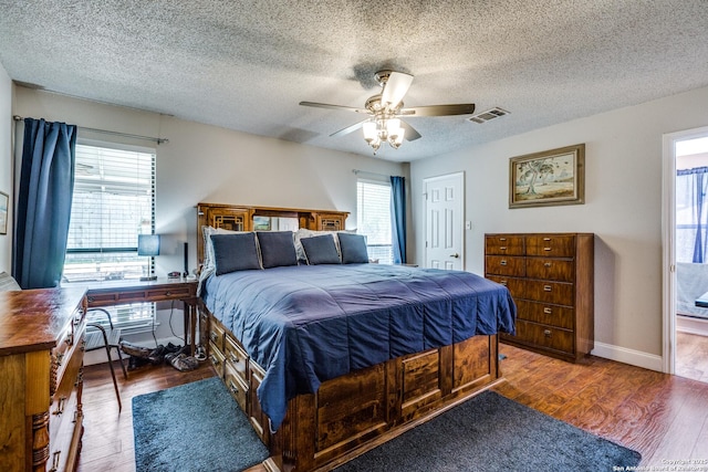 1027 Hedgestone, San Antonio, TX 78258 - bedroom with multiple windows, wood finished floors, a textured ceiling, and ceiling fan