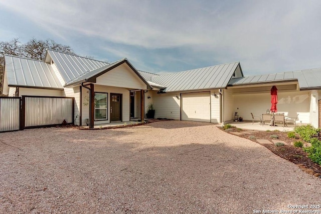 224 Frey, Boerne, TX 78006 - view of front of house featuring an attached garage, dirt driveway, a standing seam roof, and metal roof