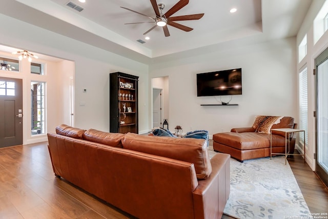 224 Frey, Boerne, TX 78006 - living room with wood finished floors, a raised ceiling, ceiling fan, a chandelier, and recessed lighting