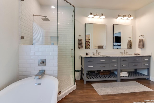 224 Frey, Boerne, TX 78006 - full bathroom with a stall shower, a soaking tub, wood finished floors, and double vanity