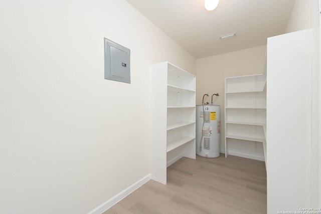 5118 Kayla Brk, San Antonio, TX 78251 - walk in closet featuring water heater, electric panel, and light wood-type flooring