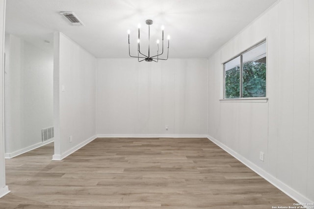 7143 Laurel Valley Dr, San Antonio, TX 78242 - unfurnished room featuring a chandelier, light wood-type flooring, and baseboards