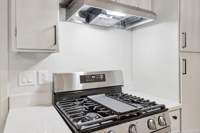 7143 Laurel Valley Dr, San Antonio, TX 78242 - kitchen featuring stainless steel gas stove, exhaust hood, light countertops, and white cabinetry