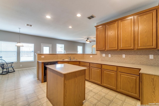 109 Sage Cyn, Boerne, TX 78006 - kitchen with light flooring, black dishwasher, a sink, a peninsula, and recessed lighting