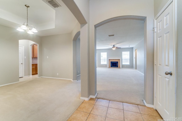 109 Sage Cyn, Boerne, TX 78006 - hallway featuring light carpet, arched walkways, baseboards, and light tile patterned flooring