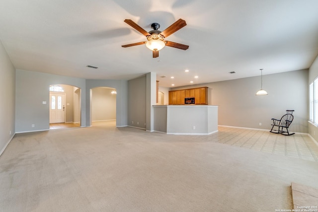 109 Sage Cyn, Boerne, TX 78006 - unfurnished living room featuring arched walkways, ceiling fan, baseboards, healthy amount of natural light, and recessed lighting