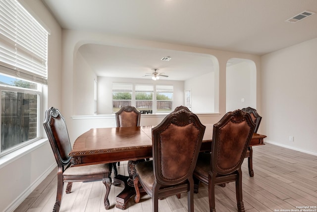 dining area with light wood-style floors, baseboards, and ceiling fan