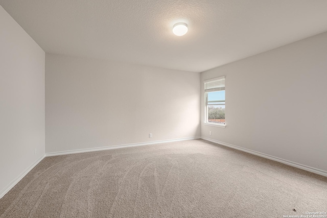 empty room with carpet floors and baseboards