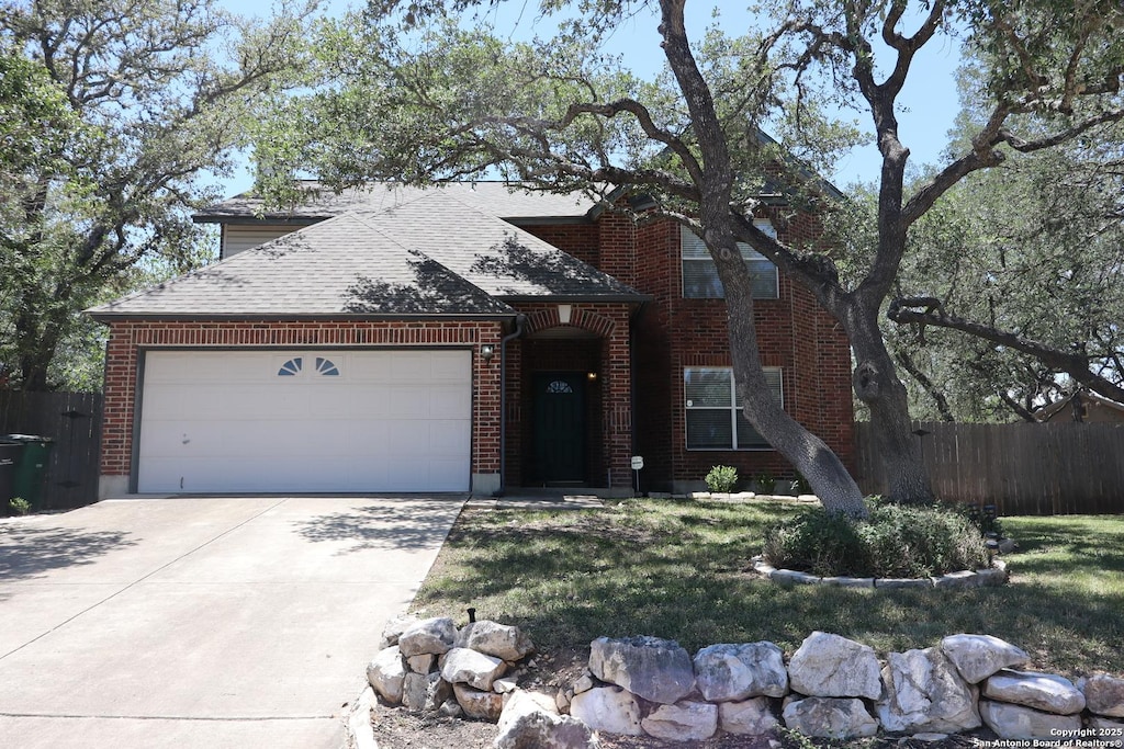 18623 Paloma Wood, San Antonio, TX 78259 - view of front of home with roof with shingles, an attached garage, concrete driveway, and brick siding