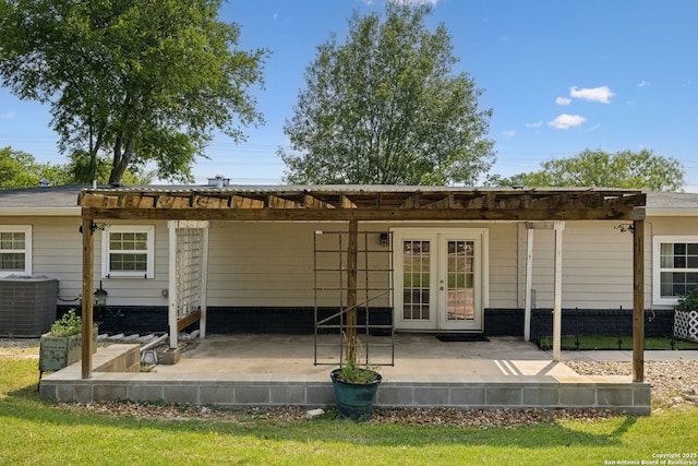 rear view of property featuring french doors, cooling unit, a pergola, and a patio area