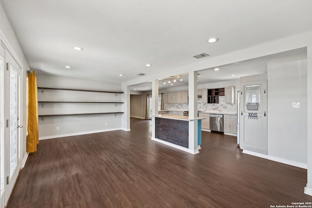 unfurnished living room featuring dark wood-style flooring, baseboards, and recessed lighting