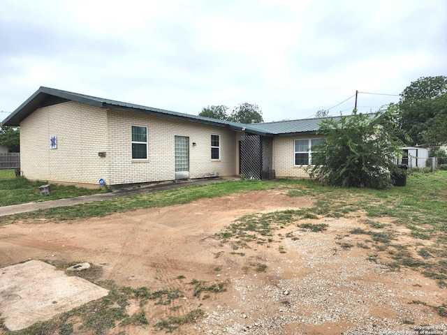610 N 9th, Carrizo Springs, TX 78834 - rear view of property with brick siding and metal roof