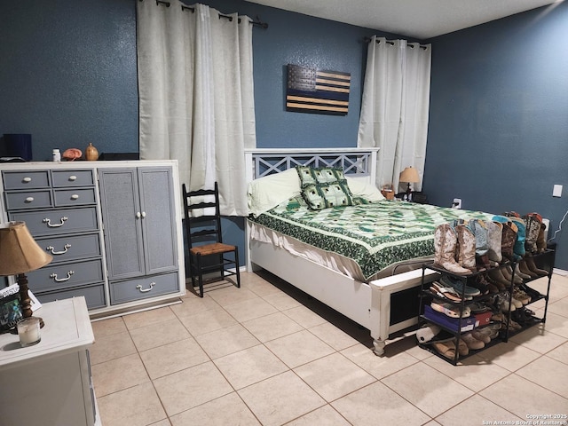 610 N 9th, Carrizo Springs, TX 78834 - bedroom featuring tile patterned flooring, a textured wall, and baseboards