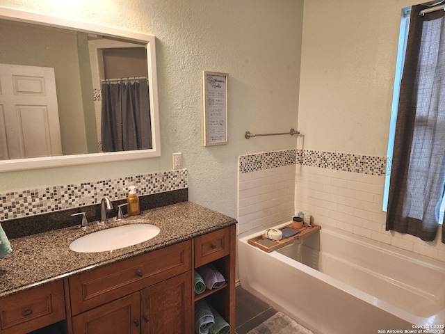 610 N 9th, Carrizo Springs, TX 78834 - full bathroom with a textured wall, vanity, a tub, and a shower with curtain