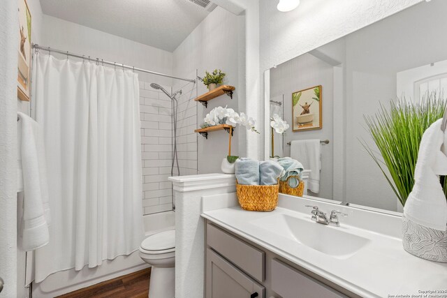 1527 Balcones Fault, New Braunfels, TX 78132 - bathroom featuring toilet, wood finished floors, shower / bath combination with curtain, and vanity