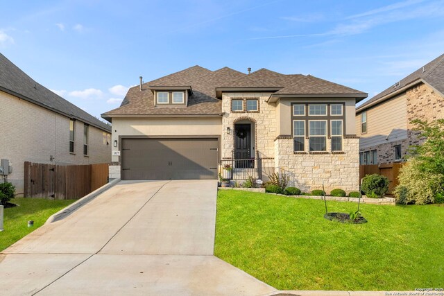 1527 Balcones Fault, New Braunfels, TX 78132 - view of front of house featuring stone siding, driveway, a garage, roof with shingles, and stucco siding